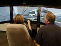 Instructor and student availing themselves of advanced driving simulation technology.