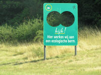 Weird Belgian road sign, featuring holes to minimize it's impact on the view of nature